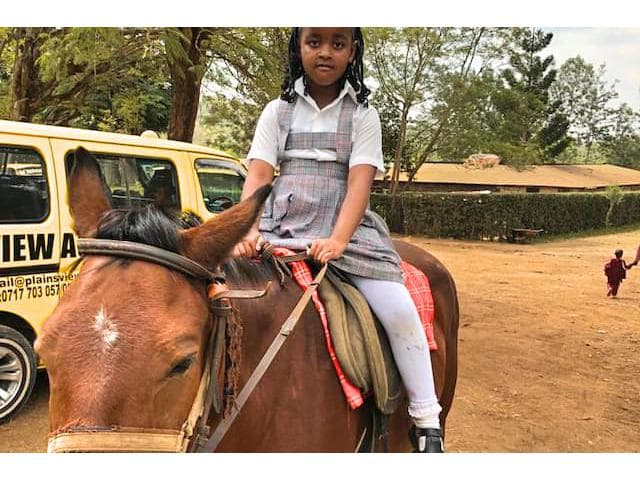Learner enjoying a pony ride at school
